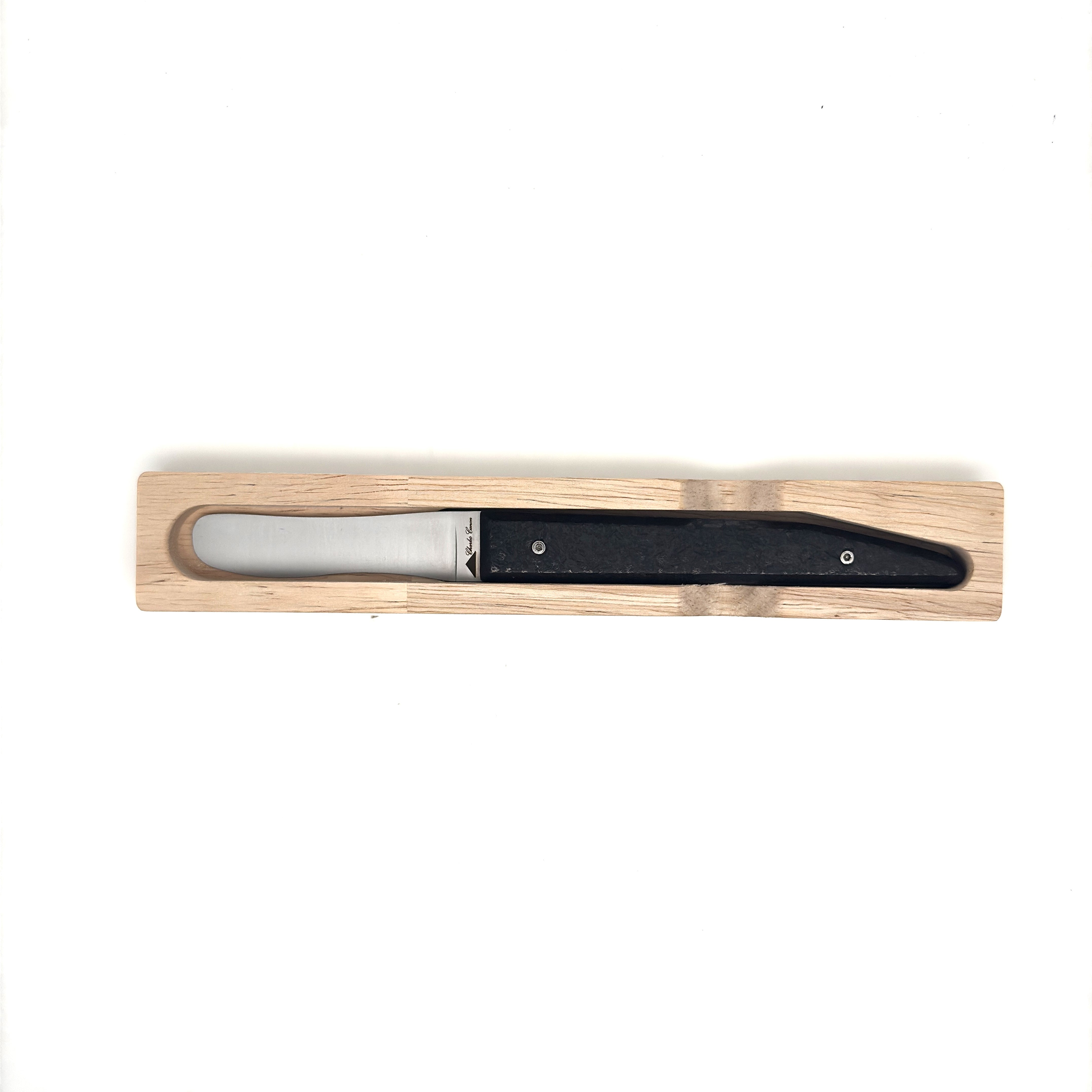 Butter knife with its raw charcoal handle