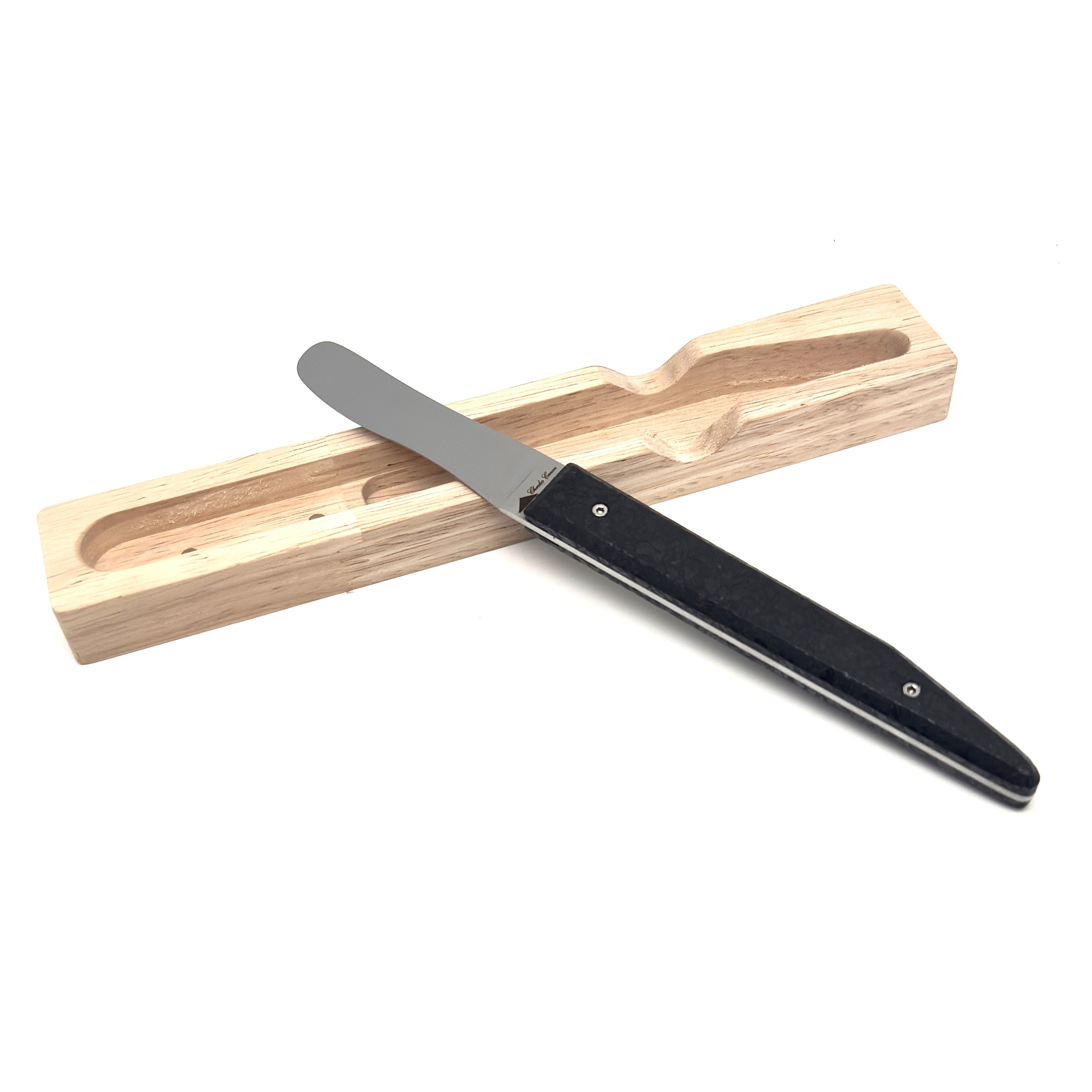 Butter knife with its raw charcoal handle