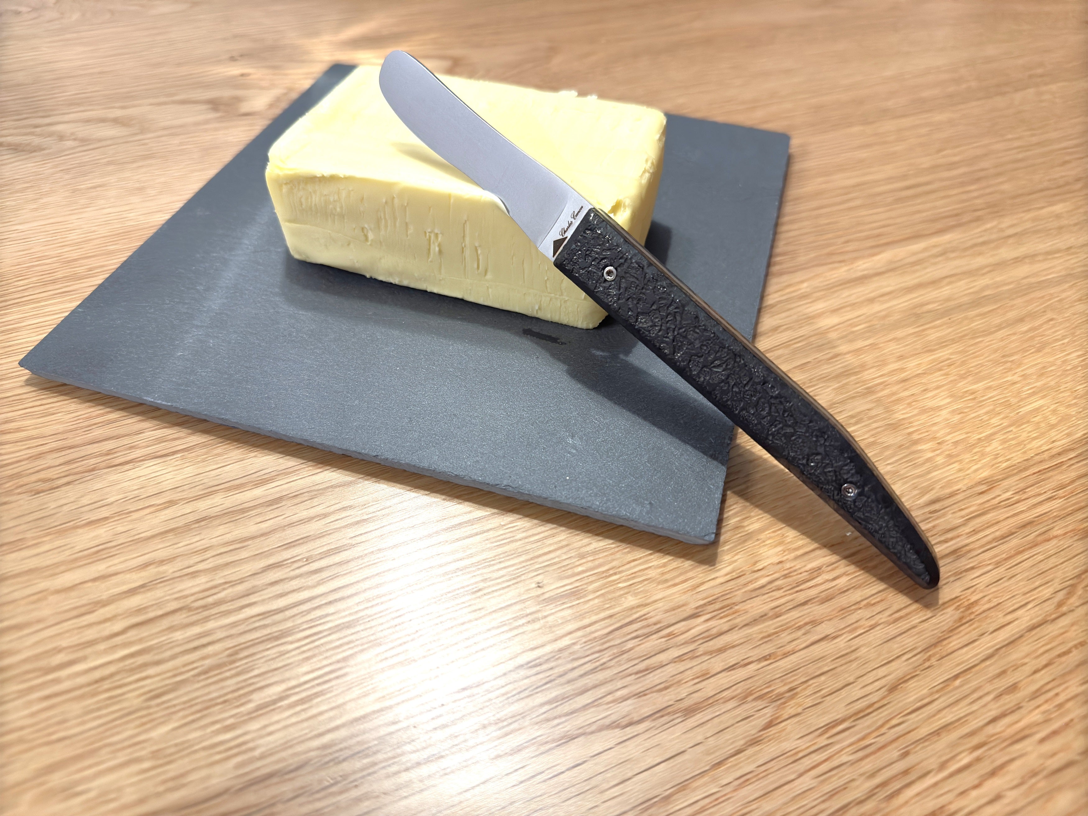 Butter knife with its raw charcoal handle