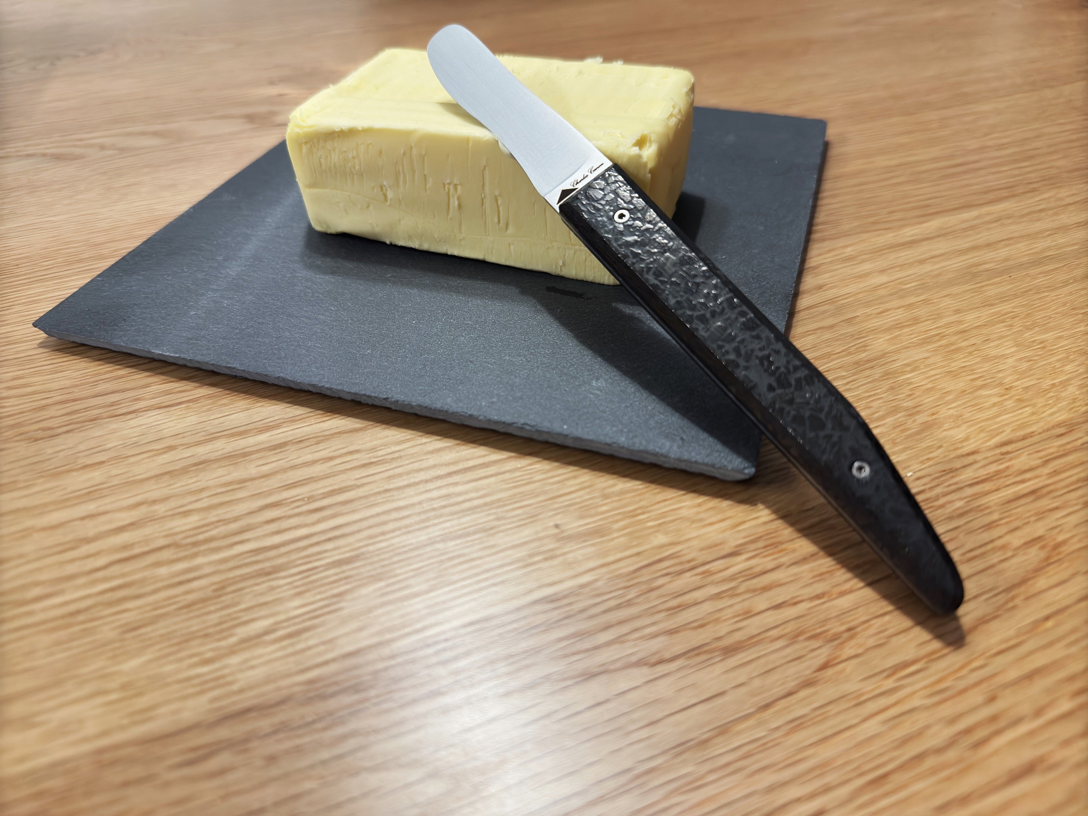 Butter knife with its shiny charcoal handle
