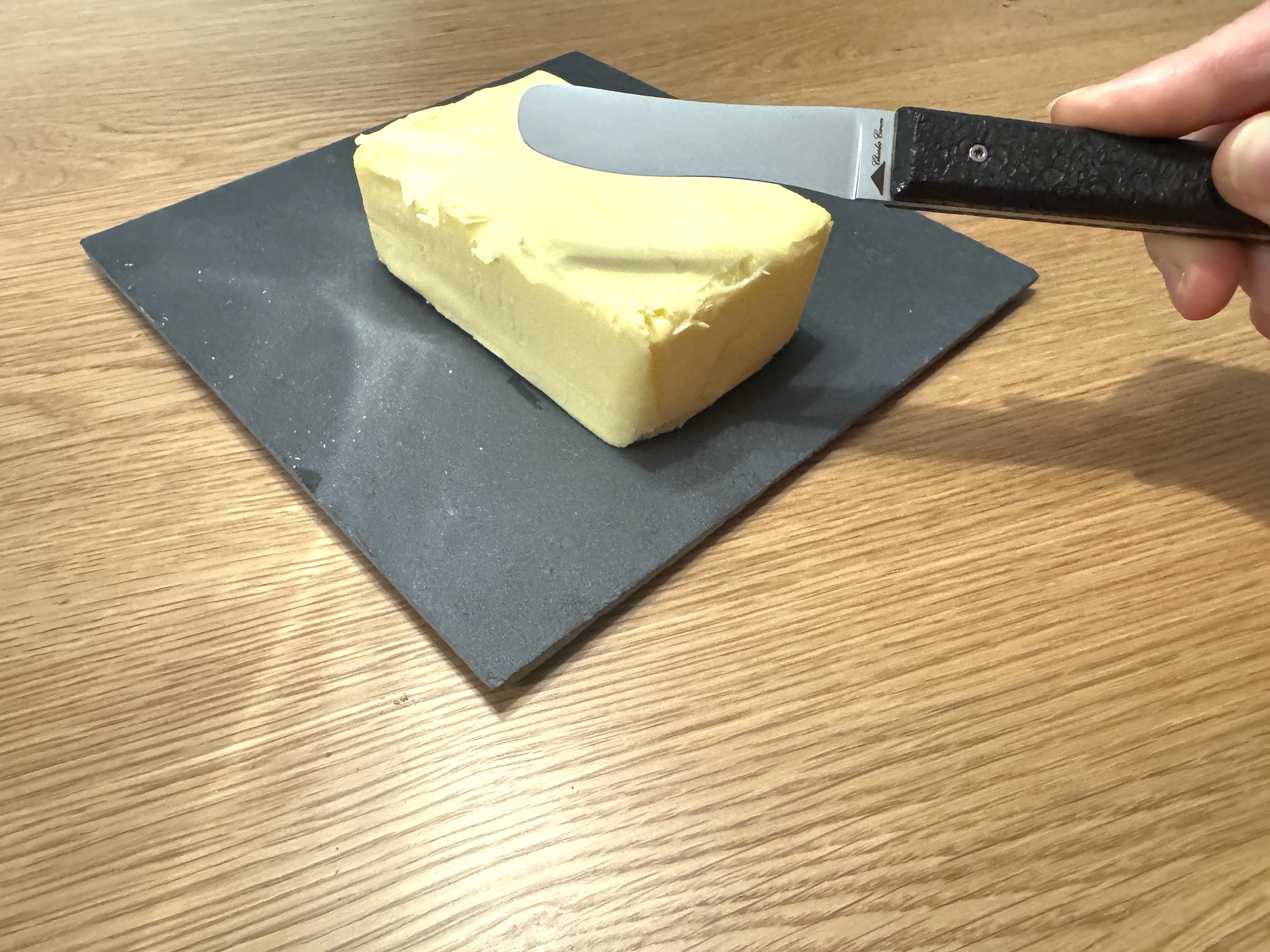 Butter knife with its raw charcoal handle