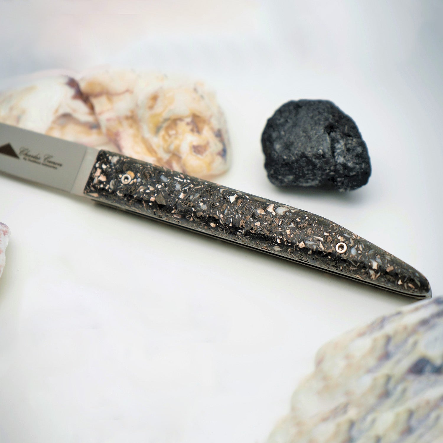 Knife with oyster shell and charcoal handle