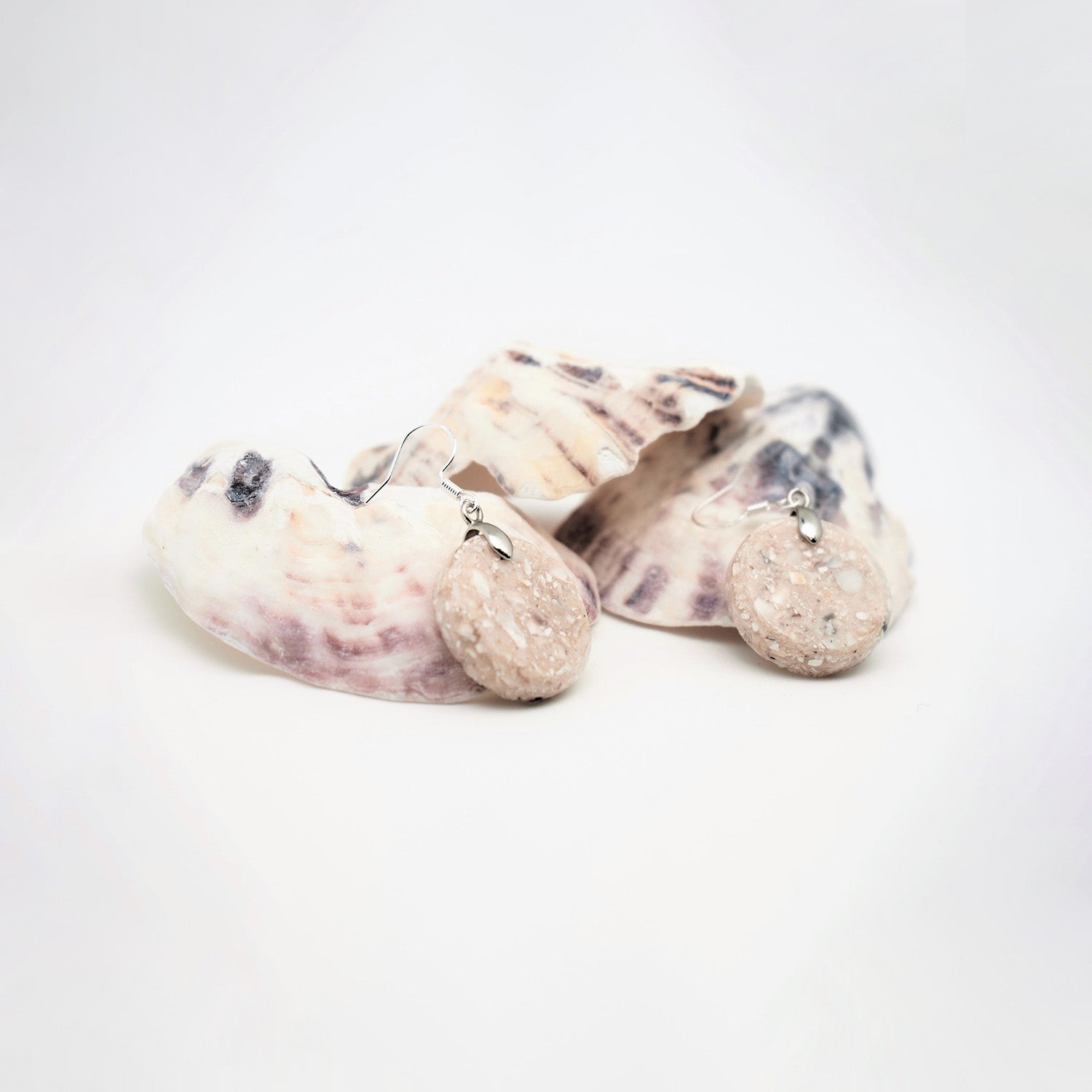 Round earrings made from recycled oyster shells