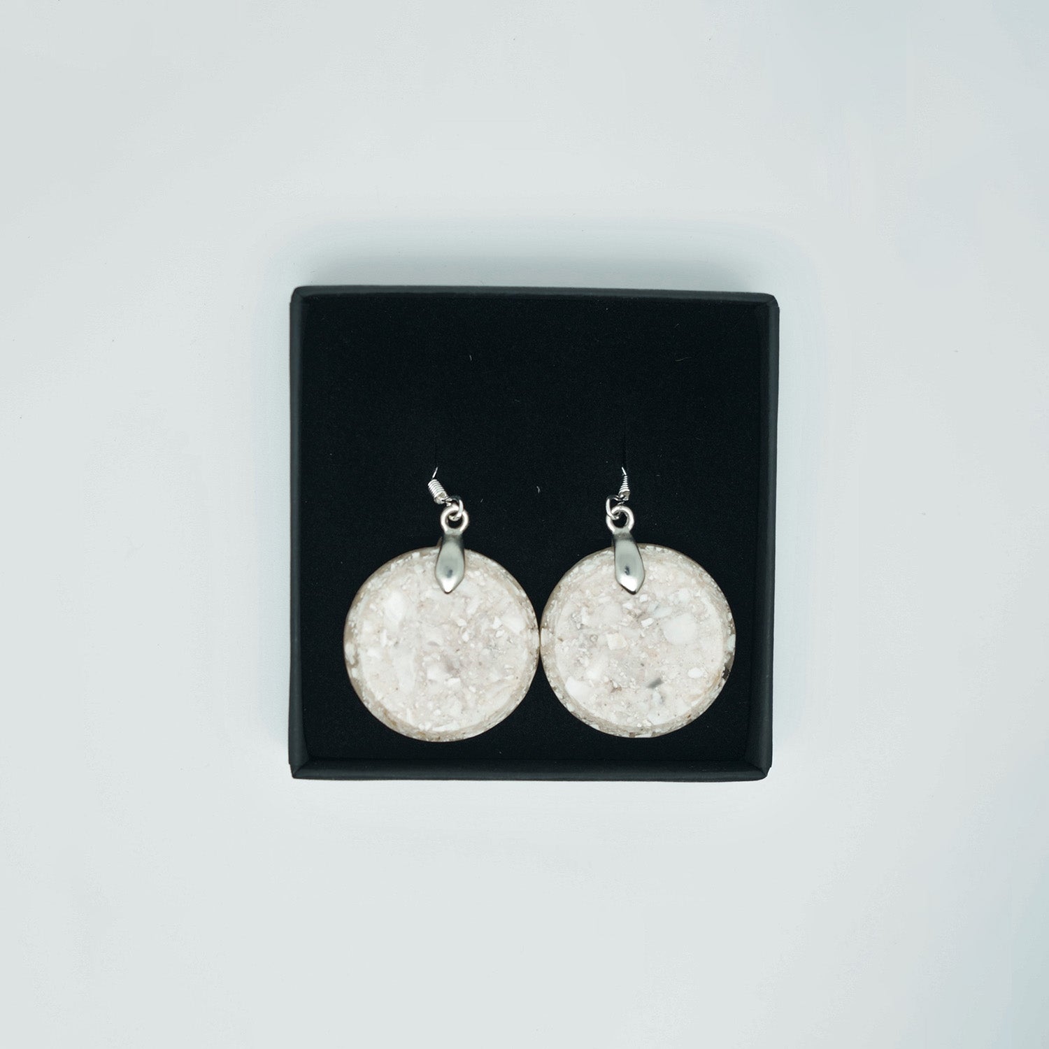 Round earrings made from recycled oyster shells